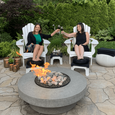 Ladies enjoying wine by the fire while having a spa party